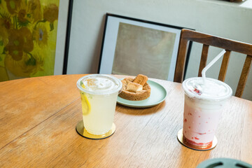 Biscoff cookie with lemonade ,strawberry milk on wooden table.