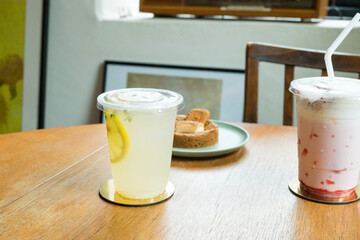 Biscoff cookie with lemonade ,strawberry milk on wooden table.