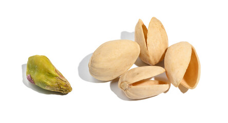 Empty shell of roasted pistachios and kernel on a white isolated background