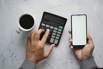 men using smart phone and calculator on table 