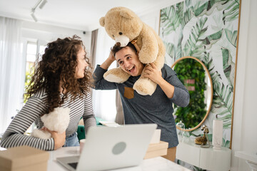 couple man and woman giving teddy bear as present happy joy and love