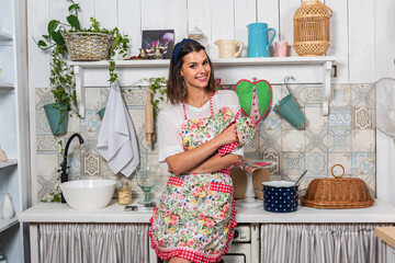 A real cute housewife cooks in the kitchen