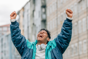 excited man with joy and success celebrating and shouting in the street