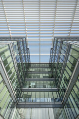 Low angle view of an office building facade built with a lot of steel and glass