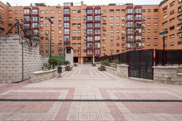 Brick facades of residential buildings with common areas with paddle tennis courts and swimming pools