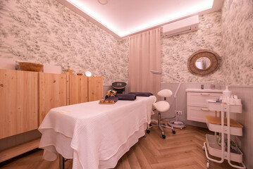 Cabin with massage table and treatments of a beauty salon and aesthetic care