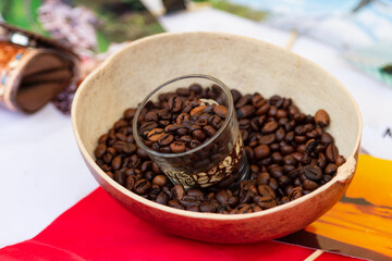 A clear glass cup filled with coffee beans, perfect for enjoying a hot coffee while admiring the beans. The unique design makes this glass a true work of art for coffee lovers.