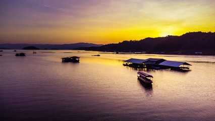 Aerial view of landscape sunset with Reservoir and raft house Thailand