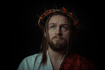 Jesus Christ wearing a crown of thorns and white chiton toga mantle cape himation suffering for...