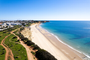 Fototapeta na wymiar Algarve Region Portugal. Lagos looking over to Praia Da Luz Beach. Beautiful Blue Skies