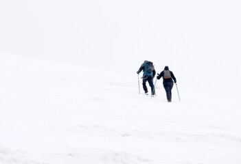 Fototapeta na wymiar Winter mountain climbing in harsh blizzard conditions, Parng Mountains, Romania, Europe 