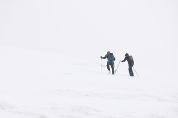 Winter mountain climbing in harsh blizzard conditions, Parng Mountains, Romania, Europe