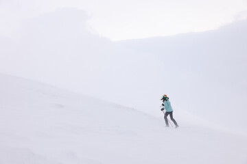 Fototapeta na wymiar Winter mountain climbing in harsh blizzard conditions, Parng Mountains, Romania, Europe