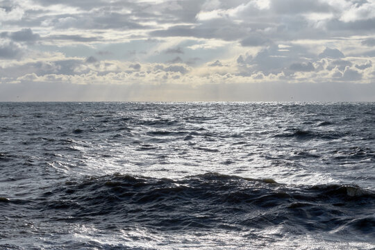 A restless sea. Sea waves. Sun glare in the waves. © Anna