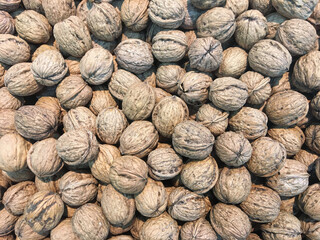 Heap of nuts inside a box, background, texture of nuts, dried fruit