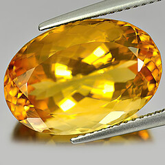 Natural gemstone yellow citrine on gray background