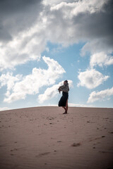 African girl with scarf in the desert.