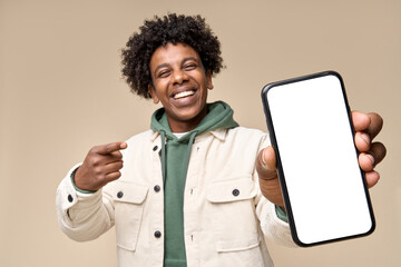 Happy African American teen student holding mobile cell phone pointing finger at smartphone mock up...