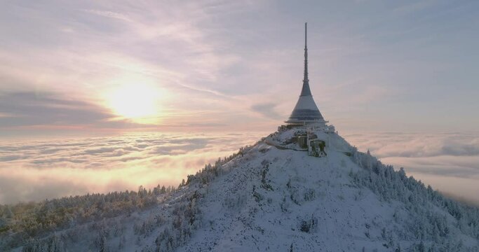 Jested tower mountain hill with snow mist and fog at golden hour