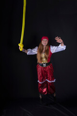 young woman dressed as a pirate in a red costume