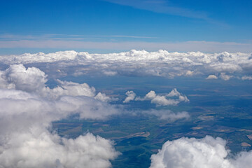 Fototapeta na wymiar sky with stormy white clouds over Ukraine view from the airplane window