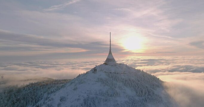 Jested tower mountain hill with snow mist and fog at golden hour