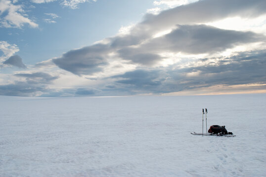 Ski mountaineering equipment laying on the snow on the glacier.
