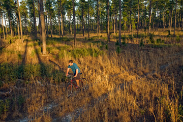 A man bikes on a trail through a part of the Green Swamp in South-east North Carolina