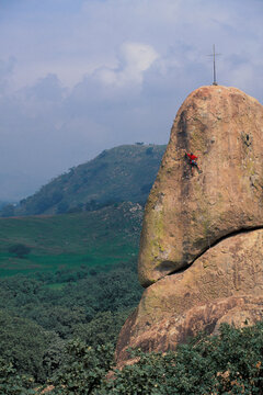 Male rock climber on a climbing route named "Desierto Verde" in the El Diente climbing area outside of Guadalajara, Mexico.
