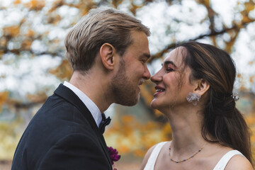 Fototapeta premium Young Wedding Couple looking at each other in fall park. High quality photo