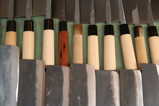 Rows of traditional Japanese cooking knives.