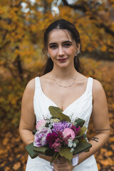 Beautiful Middle Eastern Bride with flowers looking to the camera. High quality photo