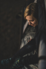 Woman talking on the phone in a tent while camping at sunset