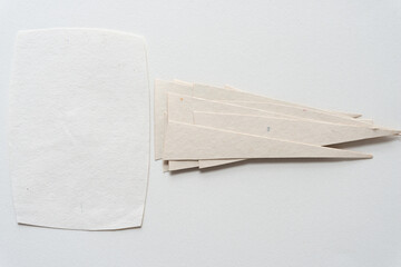 white paper card and pile of cut paper triangles on blank paper