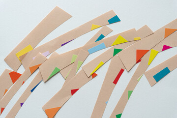 brown paper stripes with edges of colorful stickers