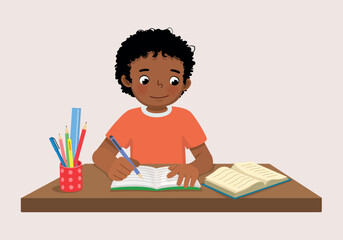 Cute little African boy sitting on the desk studying writing on notebook doing his homework at home  © Tenstudio