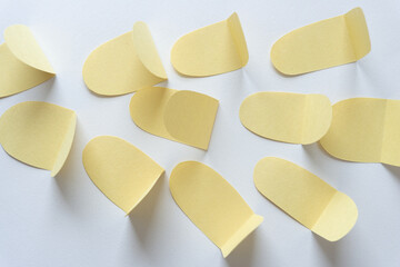 group of cut and partly folded paper shapes on blank paper