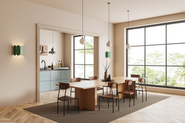 Modern kitchen interior with dining table and cooking corner, panoramic window