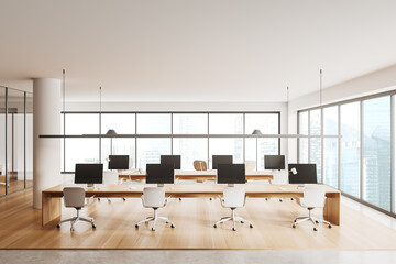 Light coworking interior with pc computer and panoramic window on skyscrapers