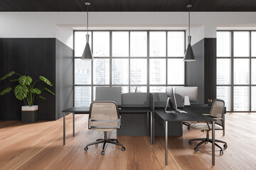 Front view on dark office room interior with computers