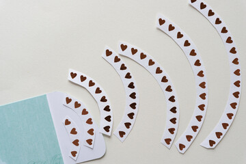 blue paper pocket envelope and curved paper stripes with hearts