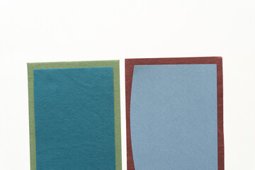 two paper backdrops in blue green and gray on white