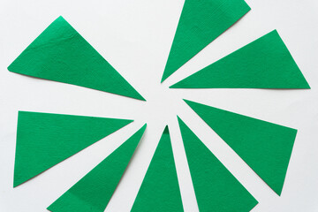 green paper triangles on white background