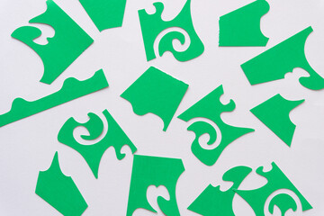 abstract green paper shapes cut from decorative stencil cutouts