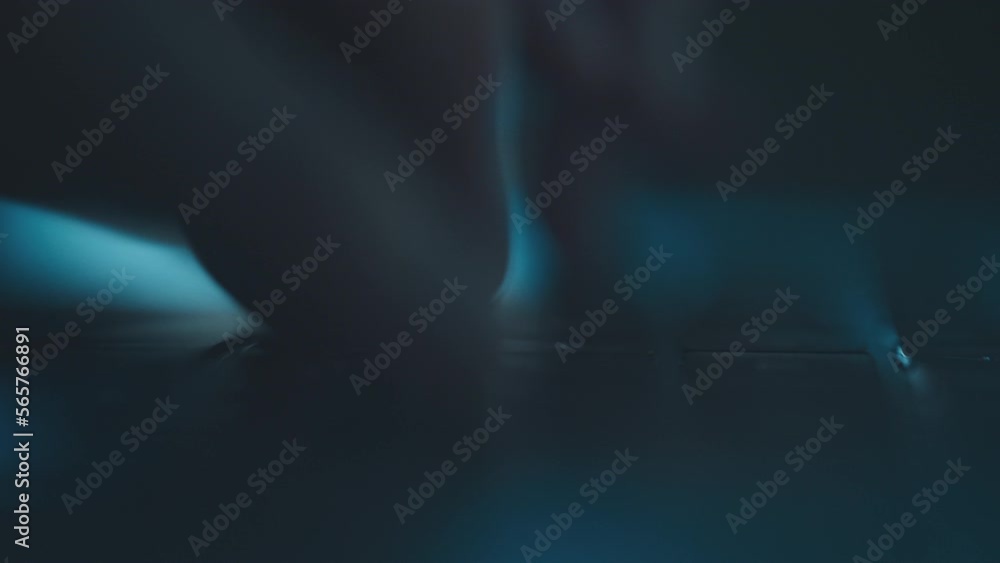 Wall mural close-up man hands typing message on laptop keyboard in slow-motion sitting at the table. blue scree