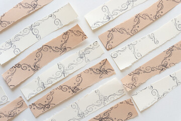 paper stripes with decorative ink shapes on blank paper