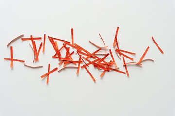 short orange paper stripes or lines scattered on blank paper