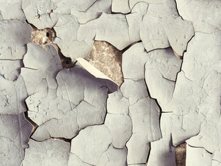 Peeling paint on the wall. Old concrete wall with cracked flaking paint. Weathered rough painted...