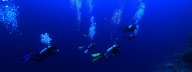 Naklejka na ściany i meble group of divers depth bubbles dive