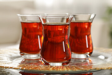 Glasses with traditional Turkish tea on table indoors, closeup